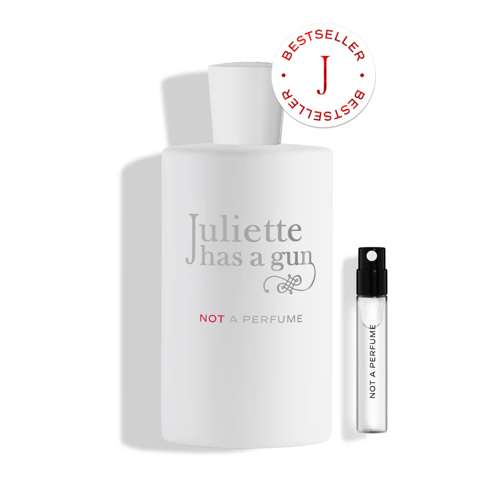 A minimalist white bottle of Juliette Has a Gun "Not a Perfume" with delicate silver typography, emphasizing its clean, singular molecular composition of Cetalox.