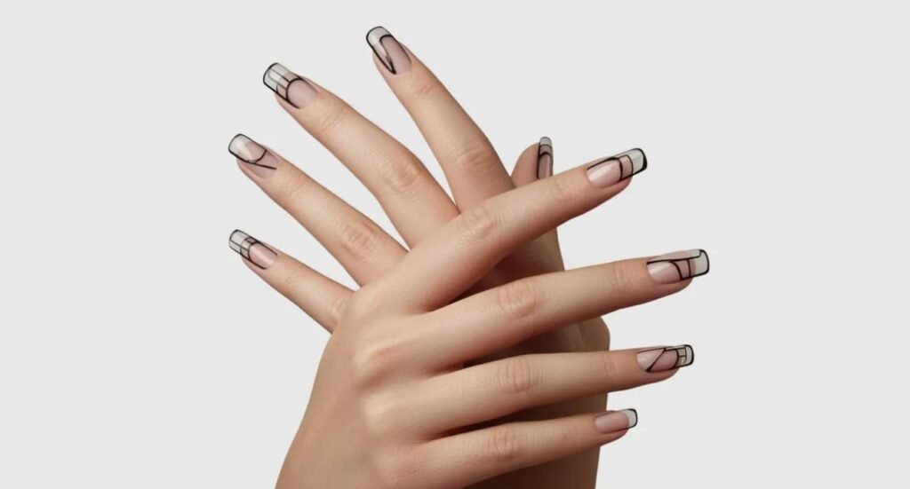 Minimalist nail art featuring thin black geometric lines on a nude base.